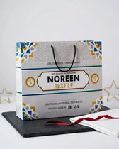 Noreen Textile branded gift bag presented with ribbon and stars